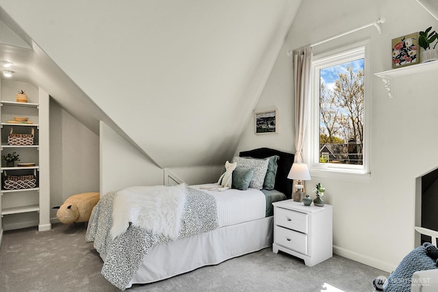 bedroom with carpet floors, lofted ceiling, and baseboards