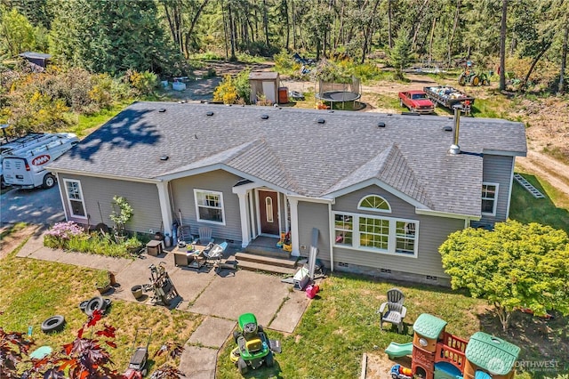 view of front of home featuring a shingled roof, a patio, and crawl space