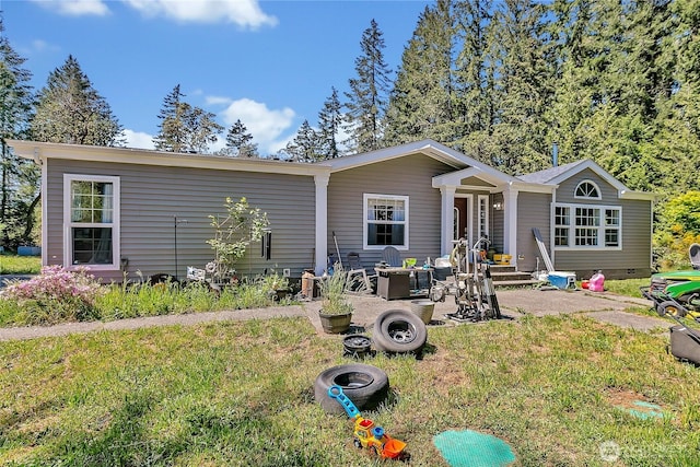 view of front of home with a patio area and a front yard