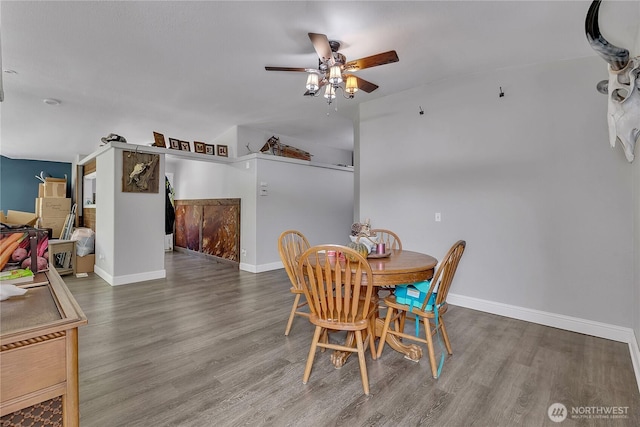 dining room featuring wood finished floors, baseboards, and ceiling fan
