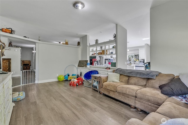 living room featuring baseboards and wood finished floors