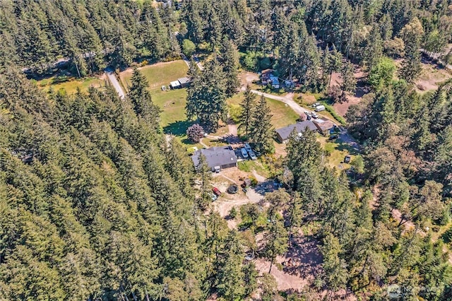 birds eye view of property featuring a view of trees