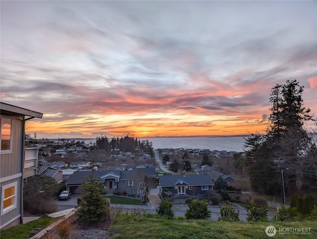 drone / aerial view featuring a water view and a residential view