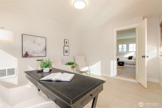 office area featuring light tile patterned floors, baseboards, and visible vents