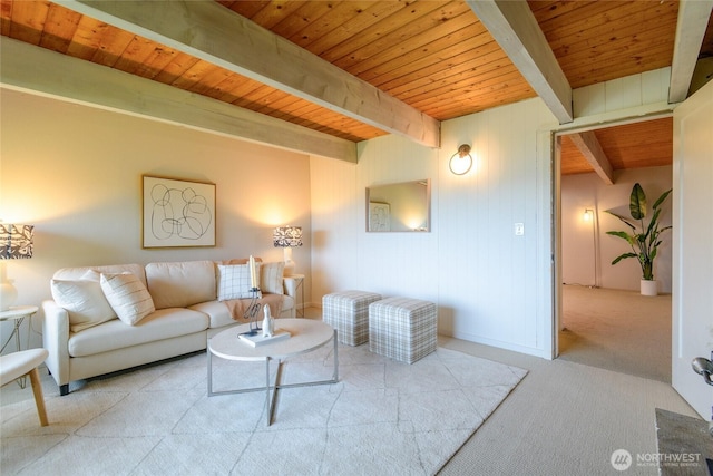 living area with beamed ceiling, wooden ceiling, and carpet floors