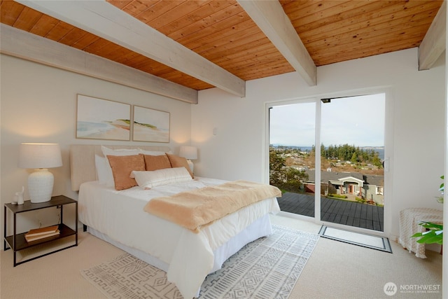 carpeted bedroom featuring beamed ceiling, wood ceiling, and access to exterior