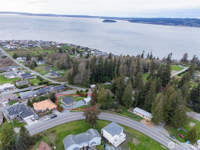 drone / aerial view featuring a water view and a residential view