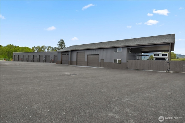 exterior space with fence and community garages