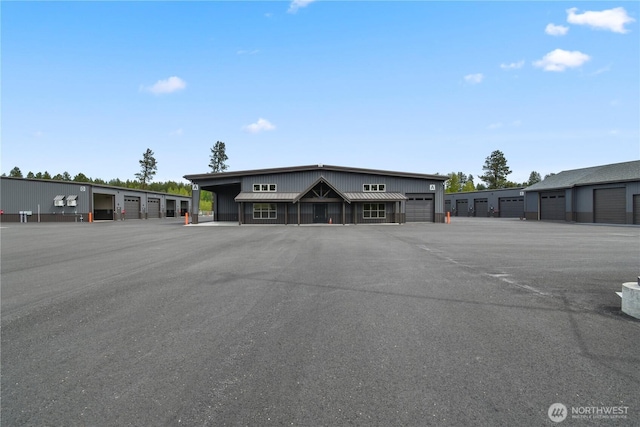 view of building exterior with community garages