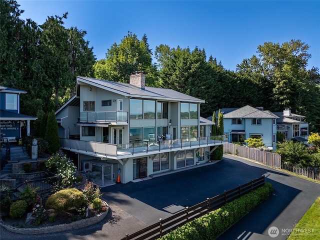 3911 NE 158th Ln, Lake Forest Park, WA 98155 - back of house with a balcony and a chimney