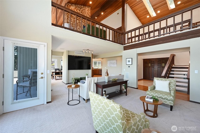 3911 NE 158th Ln, Lake Forest Park, WA 98155 - carpeted living room featuring high vaulted ceiling, stairway, wood ceiling, and a skylight