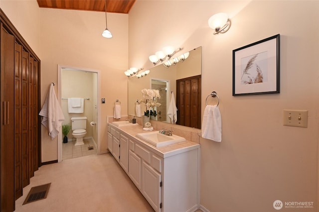 3911 NE 158th Ln, Lake Forest Park, WA 98155 - full bath with toilet, double vanity, baseboards, and a towering ceiling