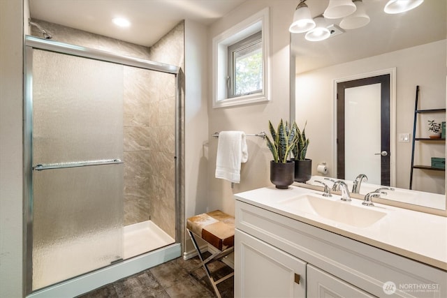full bath featuring a stall shower and vanity
