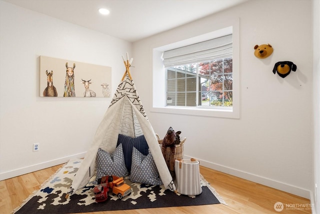 rec room with baseboards, wood finished floors, and recessed lighting