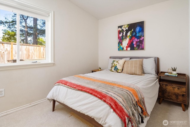 bedroom with multiple windows, carpet, and baseboards