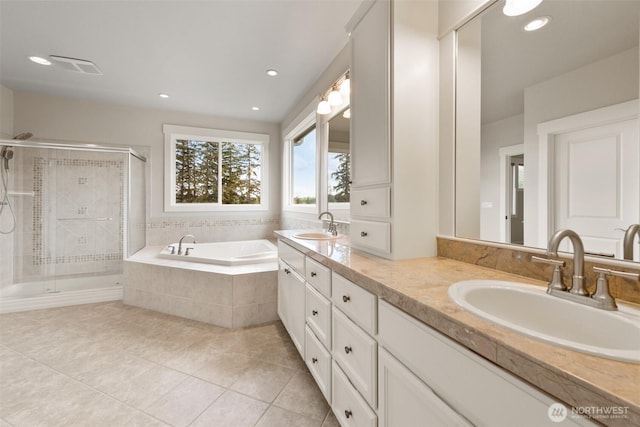 full bathroom with tile patterned floors, a bath, a shower stall, and a sink
