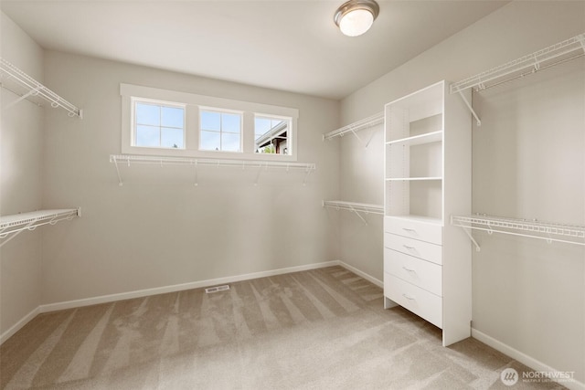 walk in closet with light carpet and visible vents