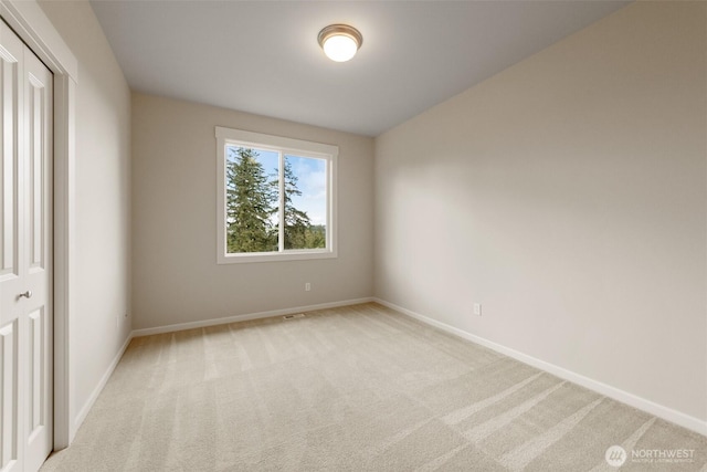 unfurnished room featuring baseboards and carpet