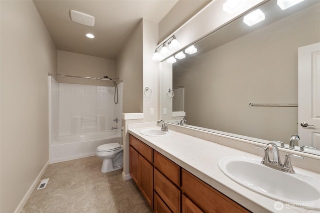 bathroom featuring a sink, double vanity, toilet, and visible vents