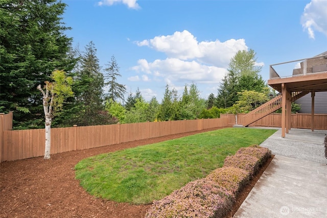 view of yard with fence and stairs