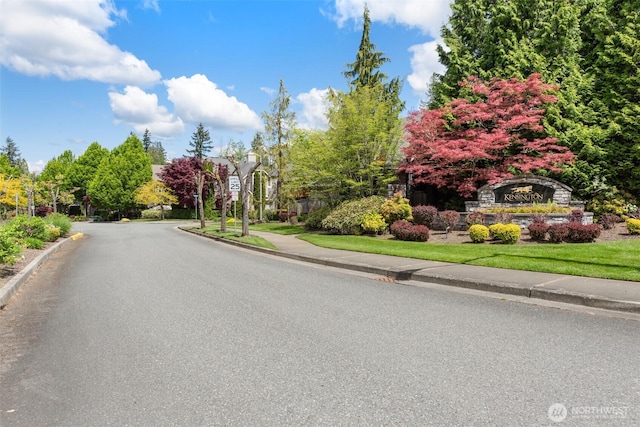 view of road with curbs and sidewalks