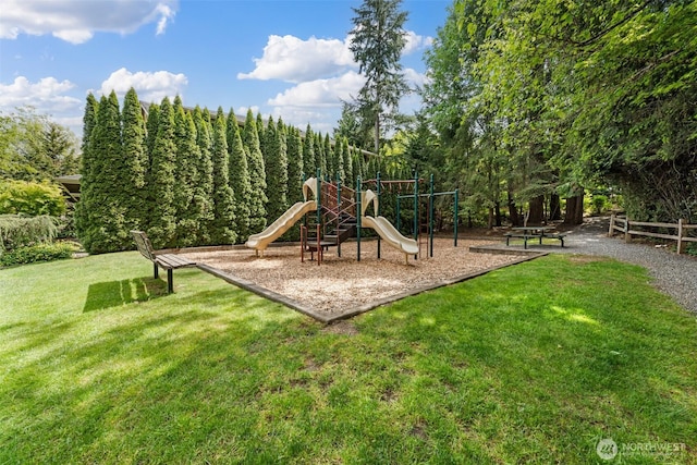 community jungle gym featuring a lawn
