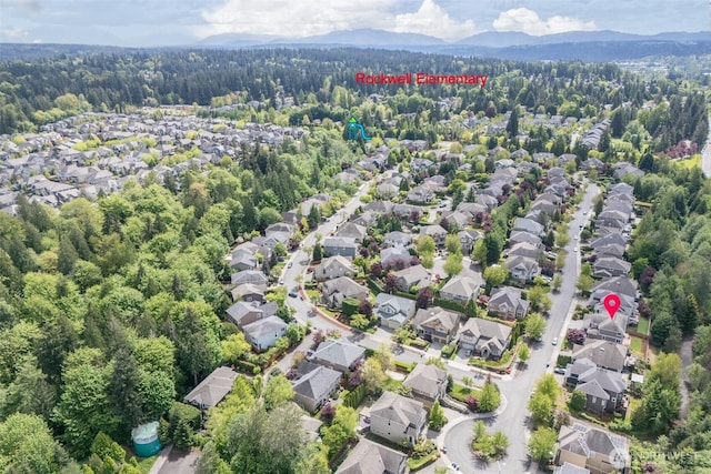 bird's eye view featuring a mountain view, a wooded view, and a residential view