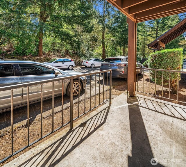 view of patio featuring view of wooded area