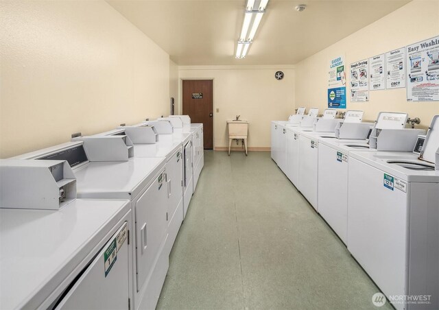 shared laundry featuring washer and clothes dryer and baseboards