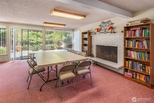 carpeted dining space with a textured ceiling and a brick fireplace