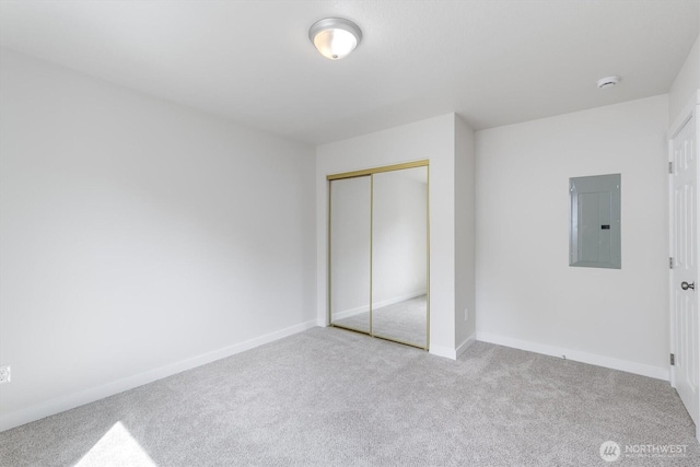 103 Madison St, Ryderwood, WA 98581 - unfurnished bedroom with electric panel, carpet flooring, a closet, and baseboards