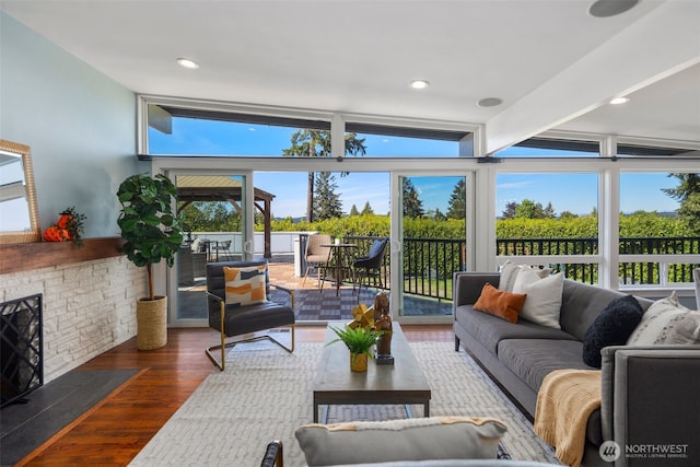 sunroom / solarium featuring expansive windows and wood finished floors