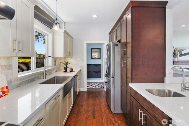 kitchen featuring a sink, freestanding refrigerator, dishwasher, exhaust hood, and recessed lighting