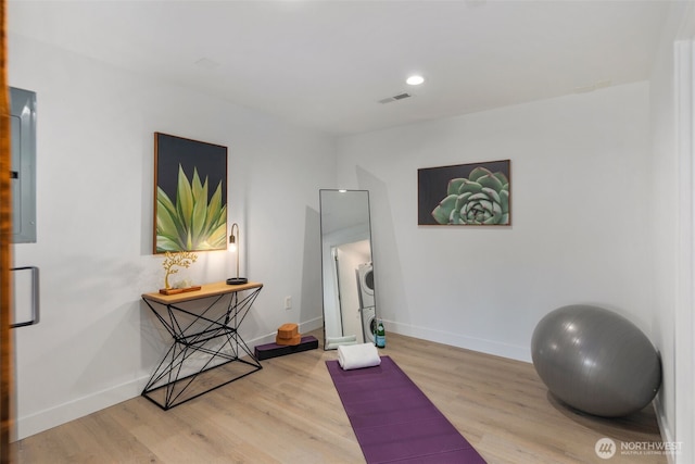 exercise area featuring wood finished floors, baseboards, and recessed lighting
