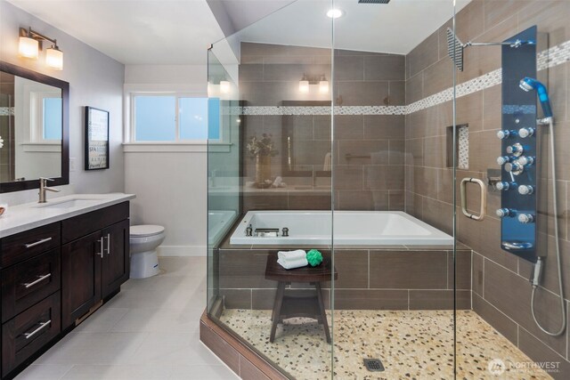 bathroom with toilet, tiled shower, vanity, tiled bath, and tile patterned flooring
