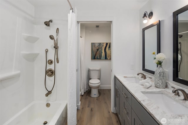 bathroom with wood finished floors, toilet, double vanity, and shower / bathtub combination with curtain