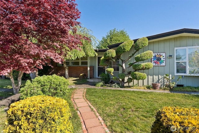 1203 Tower Ave, Raymond, WA 98577 - view of front facade with board and batten siding and a front yard