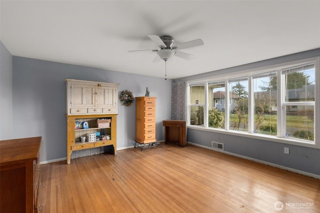 1203 Tower Ave, Raymond, WA 98577 - spare room featuring light wood-style floors, ceiling fan, and baseboards