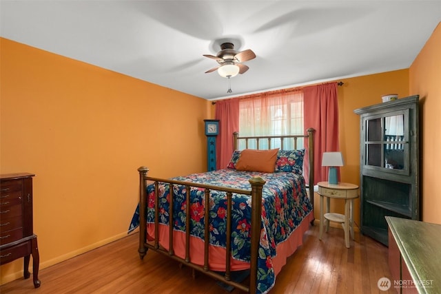 1203 Tower Ave, Raymond, WA 98577 - bedroom featuring wood finished floors, ceiling fan, and baseboards