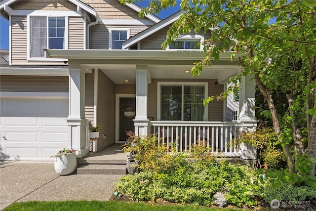 doorway to property with covered porch and a garage