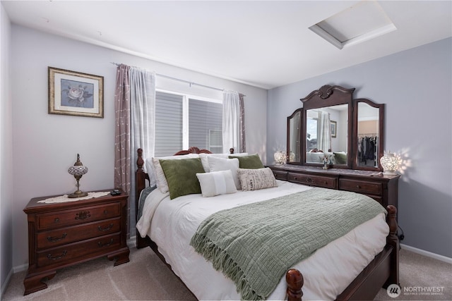 bedroom featuring light carpet, attic access, and baseboards