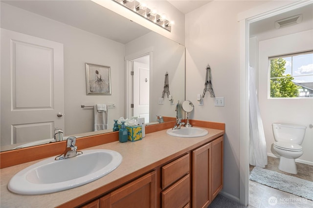 full bathroom featuring toilet, double vanity, tile patterned flooring, and baseboards