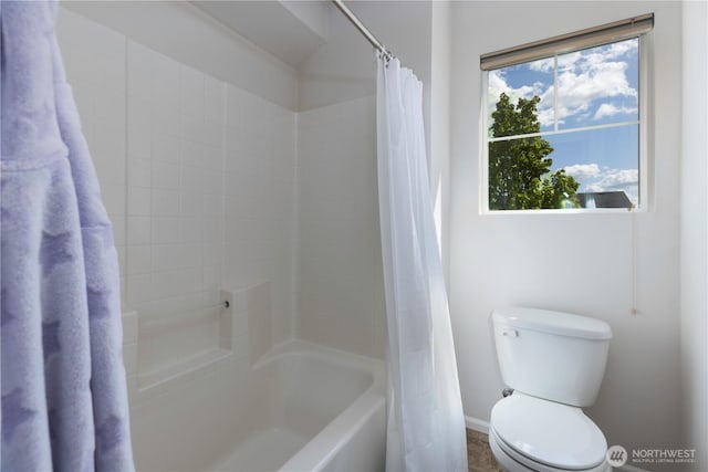 full bathroom with toilet, baseboards, and shower / tub combo with curtain