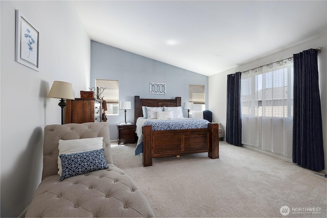 bedroom with lofted ceiling and light carpet