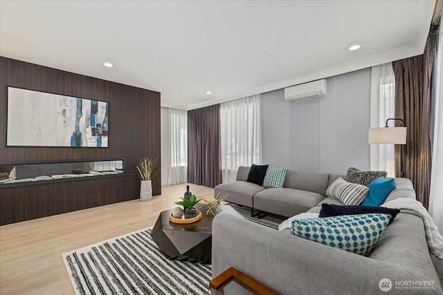 living room with an AC wall unit, wood finished floors, and recessed lighting