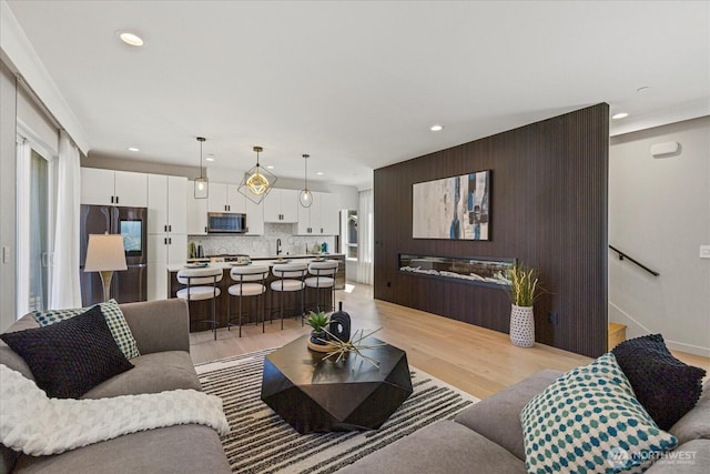 living room featuring light wood-style floors and recessed lighting
