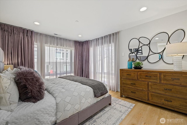 bedroom with light wood-style flooring and recessed lighting
