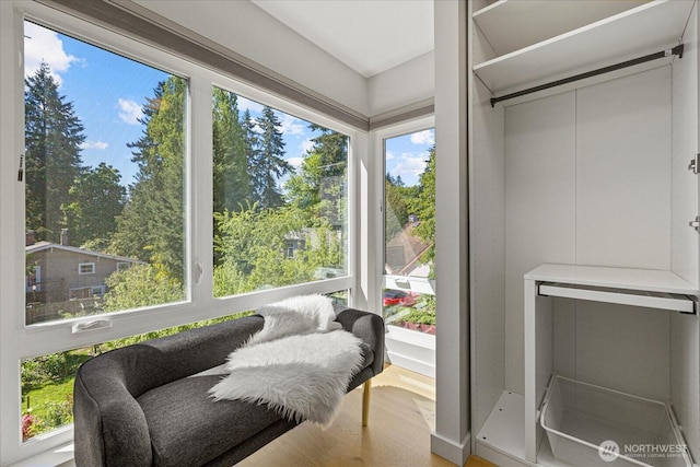 sitting room with healthy amount of natural light and wood finished floors
