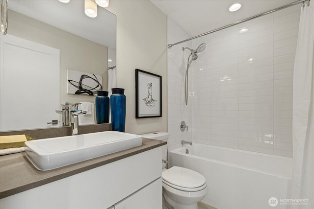 bathroom featuring toilet, shower / bath combination with curtain, and vanity