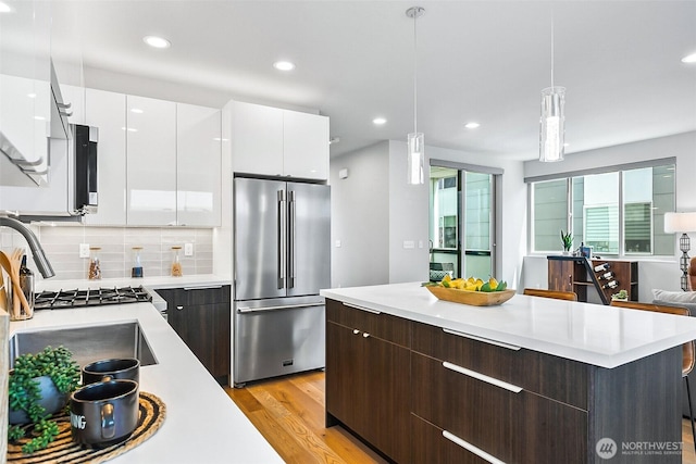 1709 NW 64th St, Seattle, WA 98107 - kitchen featuring high quality fridge, modern cabinets, light countertops, white cabinetry, and recessed lighting